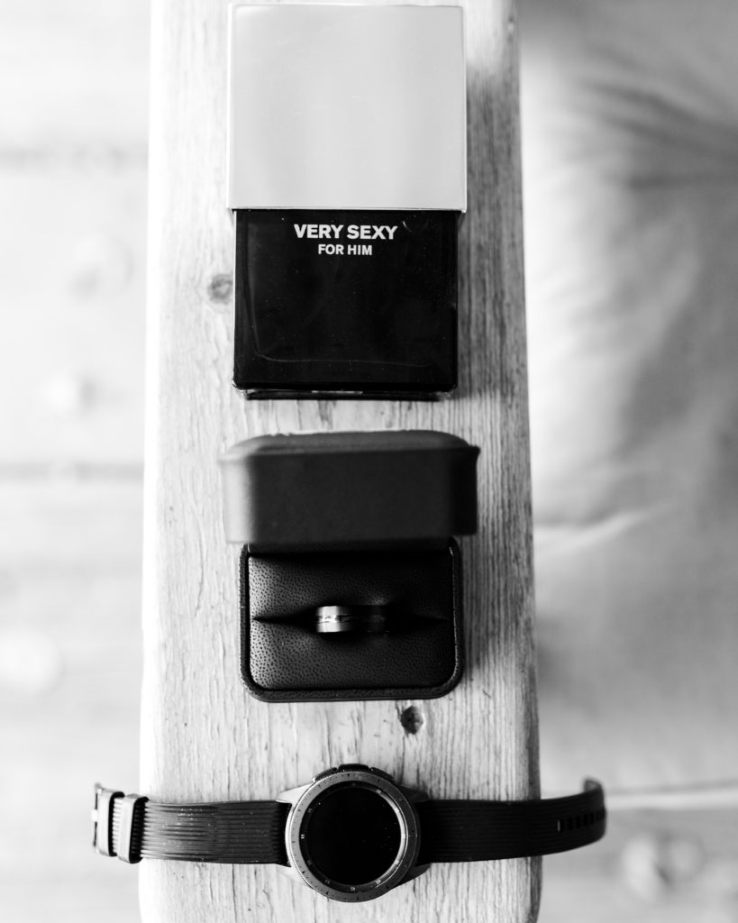 Groom's cologne, ring, and watch on his wedding day.