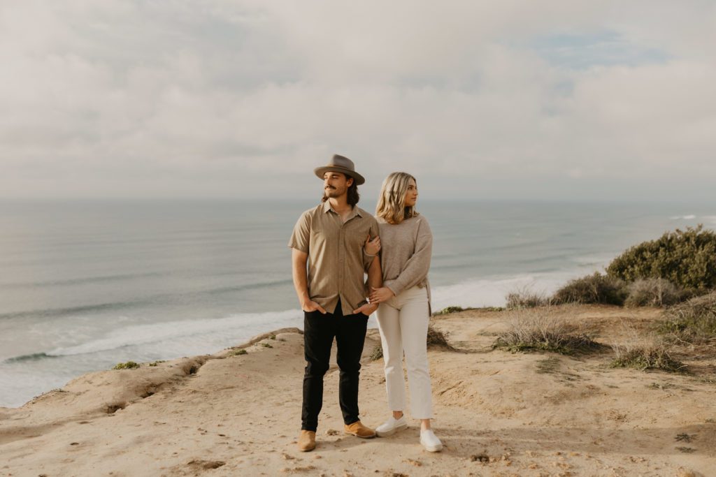 Couple wearing neutral colors for photos at Torrey Pines Gliderport.