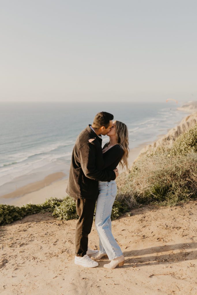 couple kissing on the cliffs of La Jolla