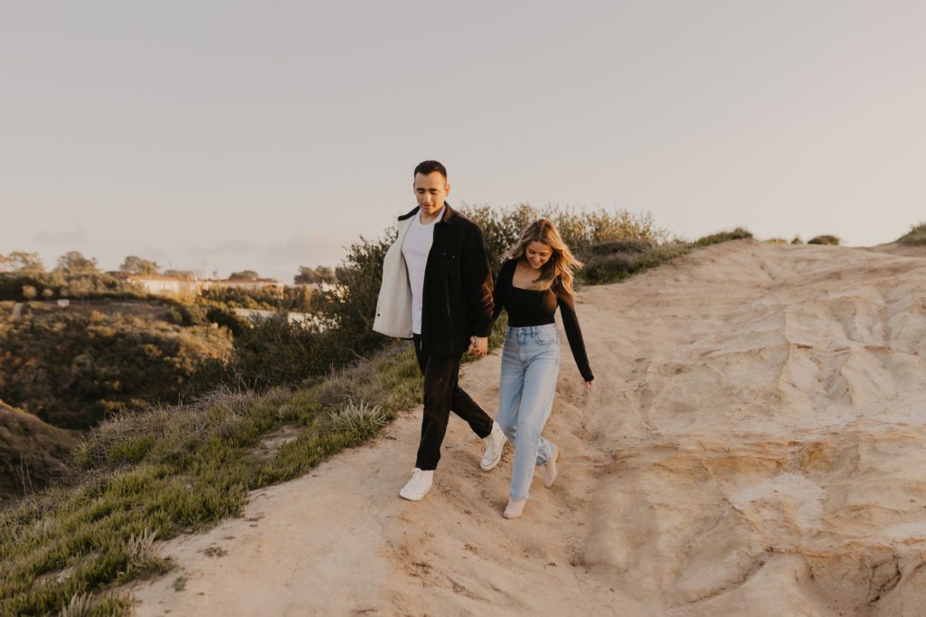 Couple walking down the cliffs of La Jolla