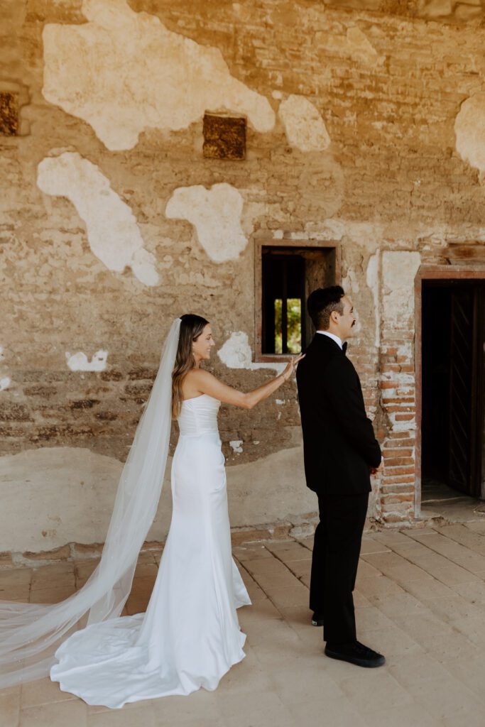 Spanish style wedding photos first look at Mission San Juan Capistrano