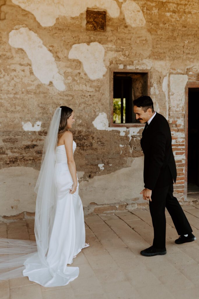 Spanish style wedding photos first look at Mission San Juan Capistrano