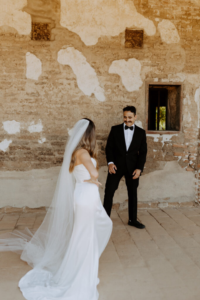 Spanish style wedding photos first look at Mission San Juan Capistrano