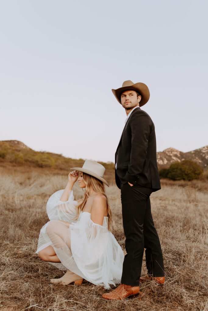 Showing off Tecovas boots during a western engagement session